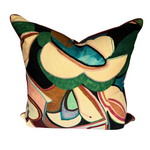 A square decorative throw pillow featuring an abstract, organic pattern in green, beige, black, brown, and teal, set against a plain white background.