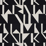 Black and off-white geometric patterned fabric featuring a bold abstract design of arrows and lines.