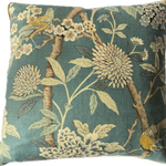 Hydrangea Bird Decorative pillow with floral and bird pattern on a teal background.