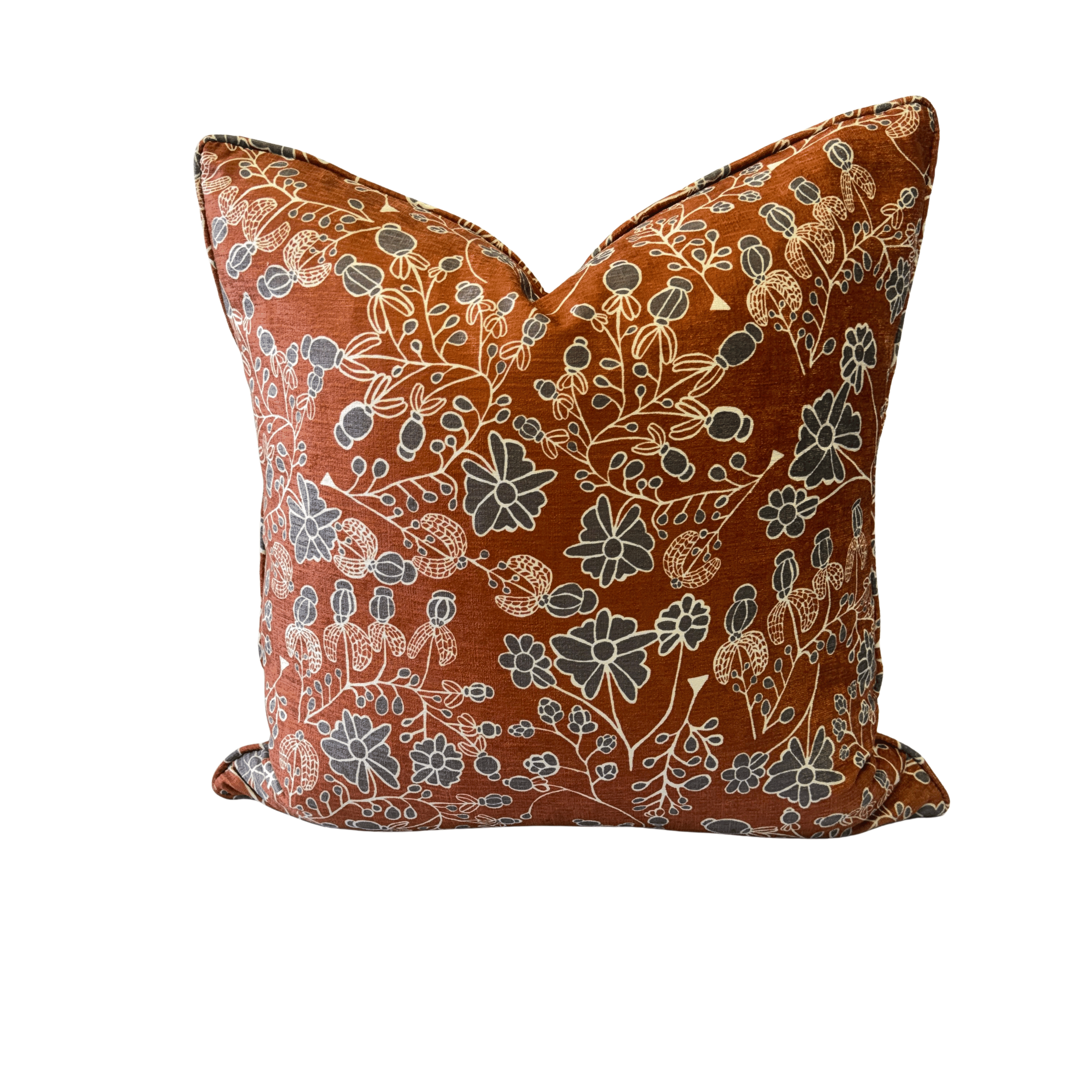A square decorative throw pillow with a rust-orange background and an intricate floral pattern in cream, beige, and slate blue, shown against a plain white background.