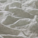 Linia Sheer Tiamo Laurel off-white linen fabric with a soft, textured weave and gentle shadows.