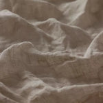 Linia Sheer Tiamo Linen light beige linen fabric with a soft, textured weave and gentle shadows.