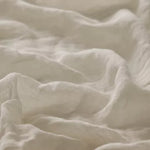 Linia Sheer Tiamo oyster off-white fabric with a textured, slightly wrinkled surface.