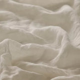 Linia Sheer Tiamo oyster off-white fabric with a textured, slightly wrinkled surface.