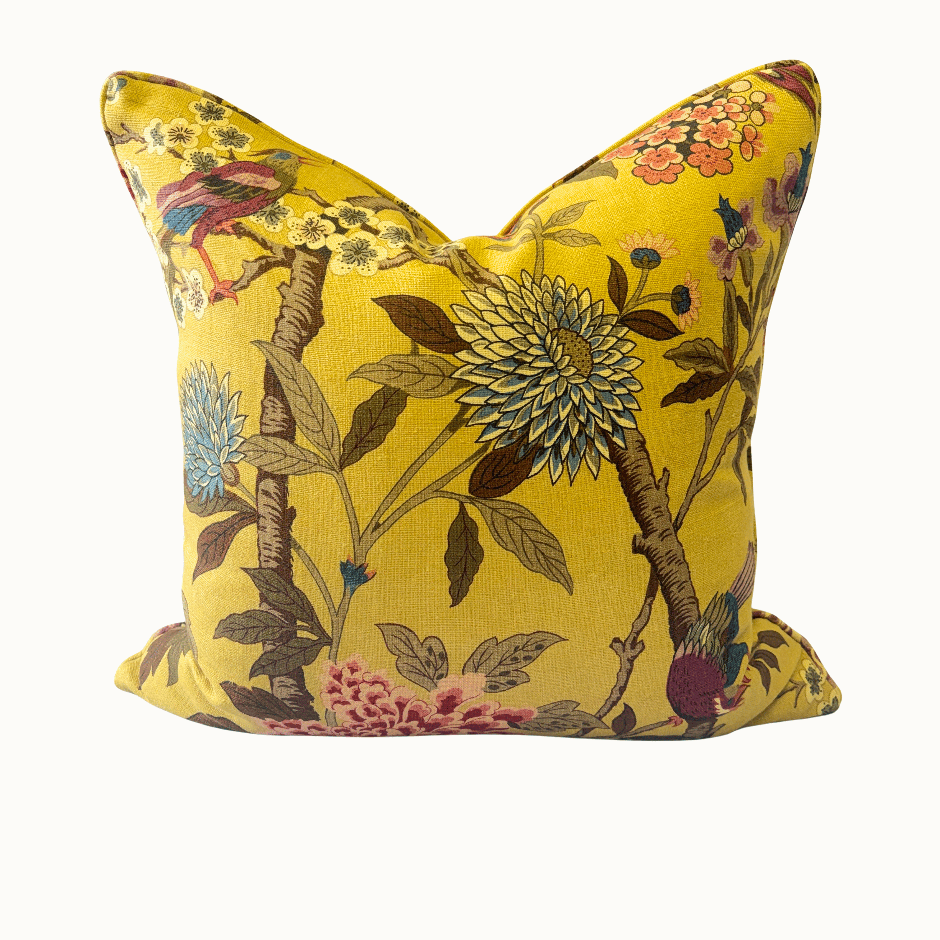 A square decorative throw pillow with a vibrant yellow background and an intricate botanical and bird pattern, shown against a plain off-white background.