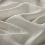 linia Inari natural drapery fabric. Close-up of light-colored fabric with subtle texture