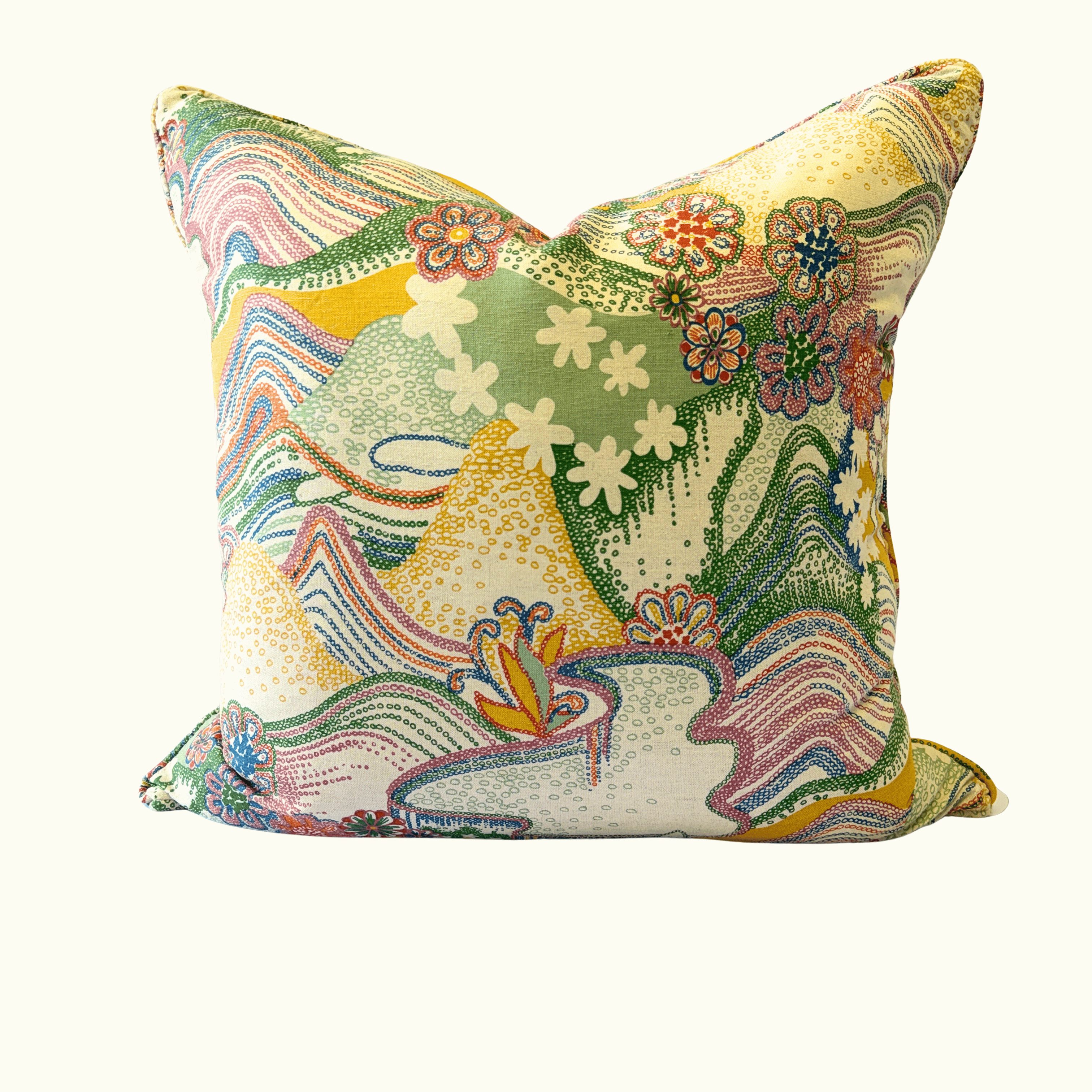 A square decorative throw pillow featuring a vibrant, multicolored abstract landscape pattern with mountains, waves, and flowers on a cream background.